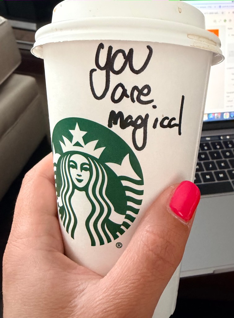 Coffee cup that says "You are magical" on it.